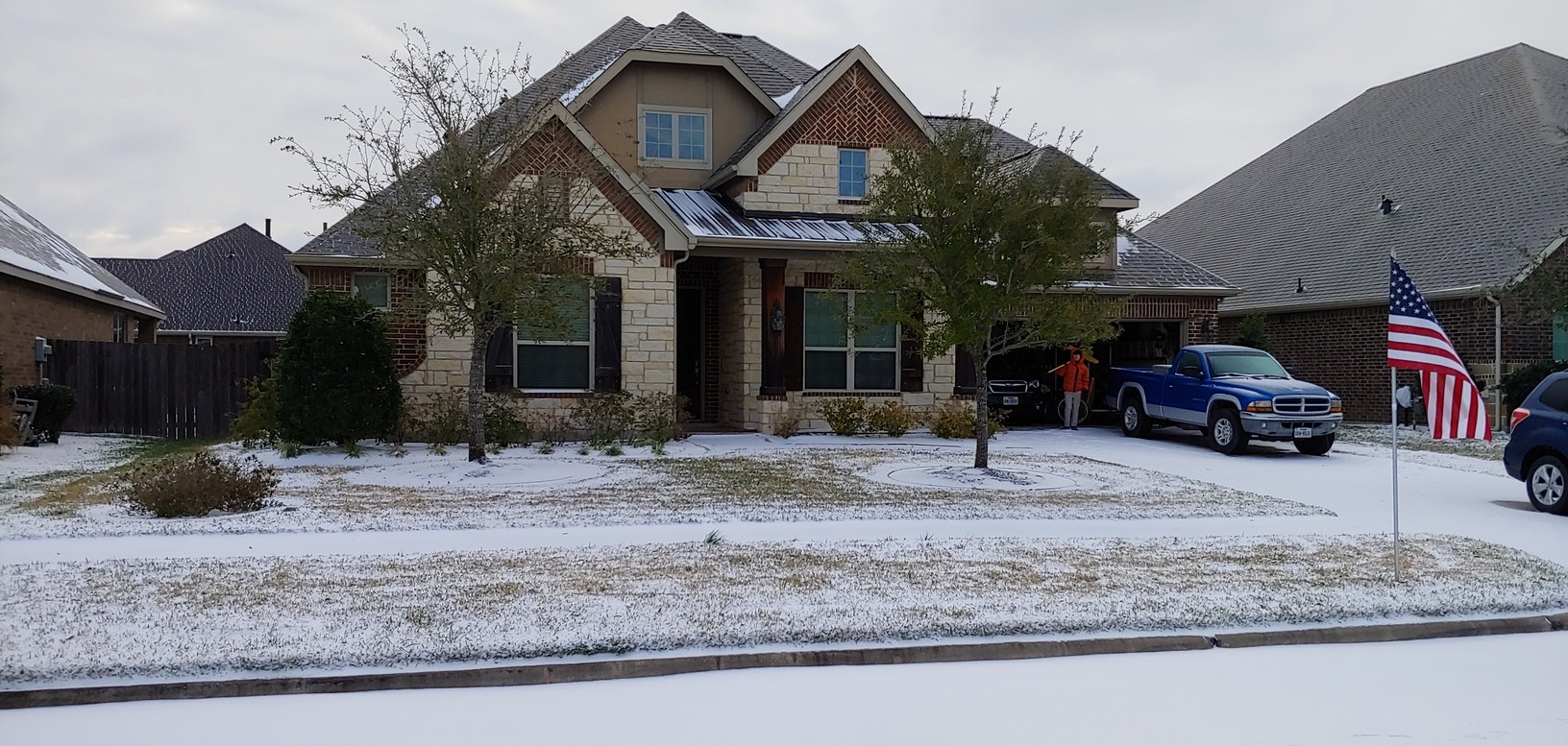 Our house with snow on the ground and Wilson in the garage