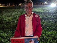 PXL 20260518 033210590  Retrieving his yard sign from the front of Katy High School